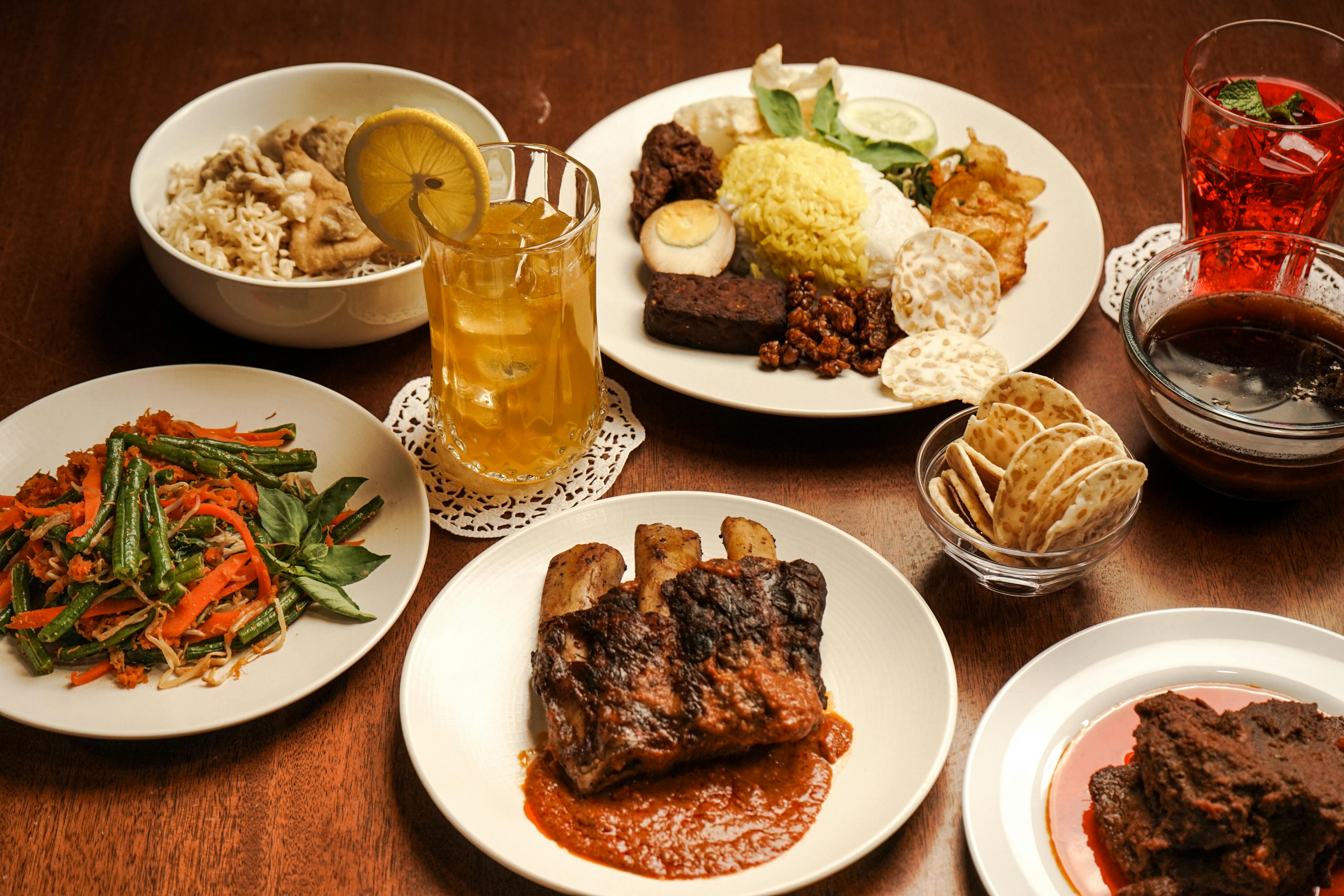 A variety of traditional Indonesian dishes served on a wooden table, perfect for a cultural dining experience.