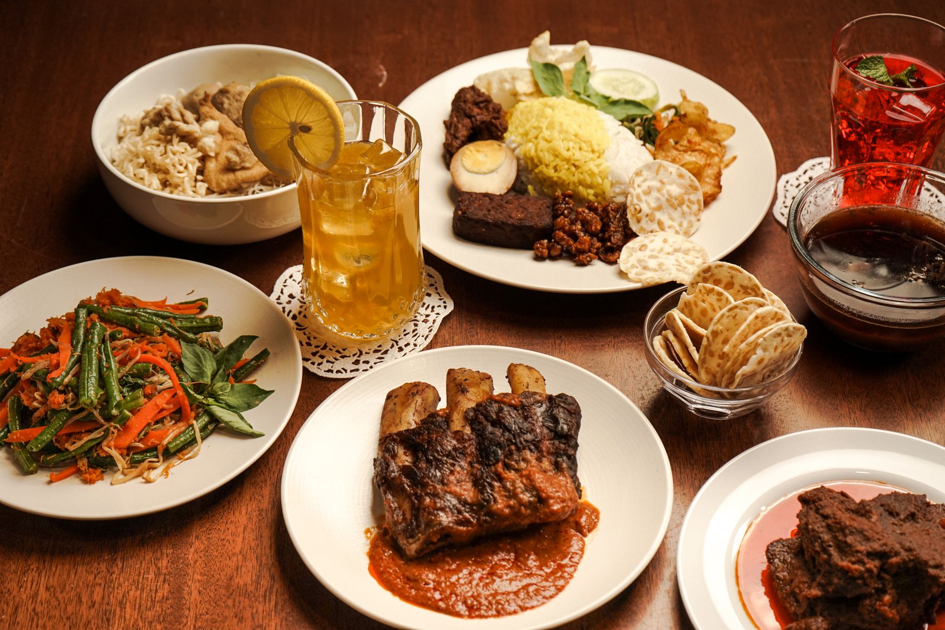 A variety of traditional Indonesian dishes served on a wooden table, perfect for a cultural dining experience.