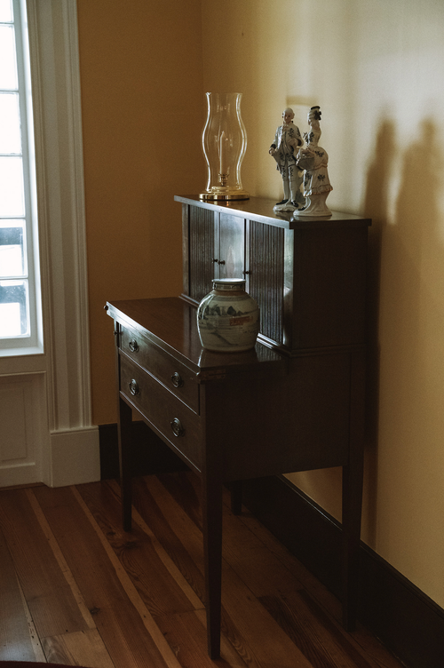 Free Antique wooden console table with decorative vases in a cozy interior corner. Stock Photo