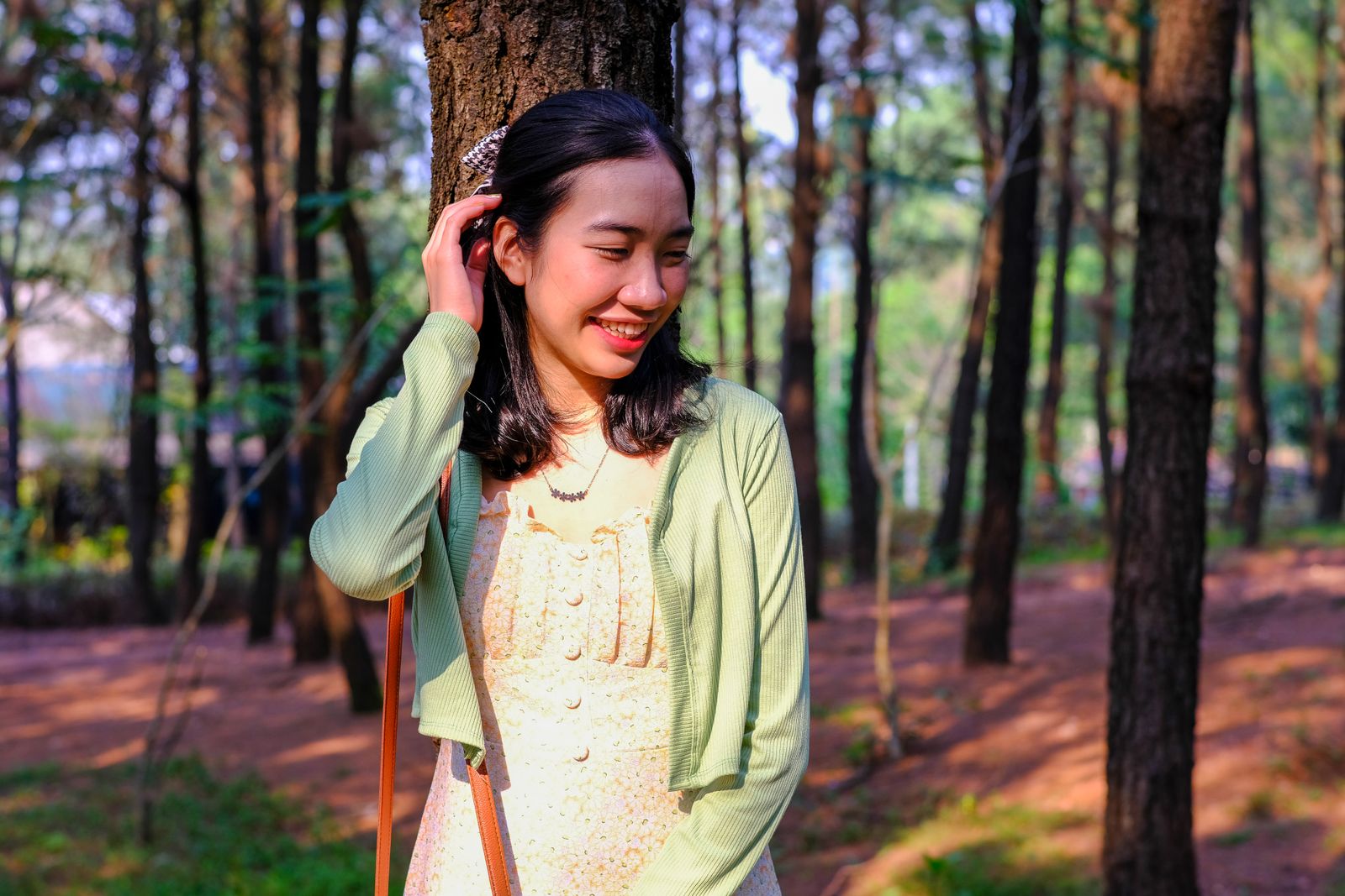 Woman wearing a seafoam cardigan over a floral dress