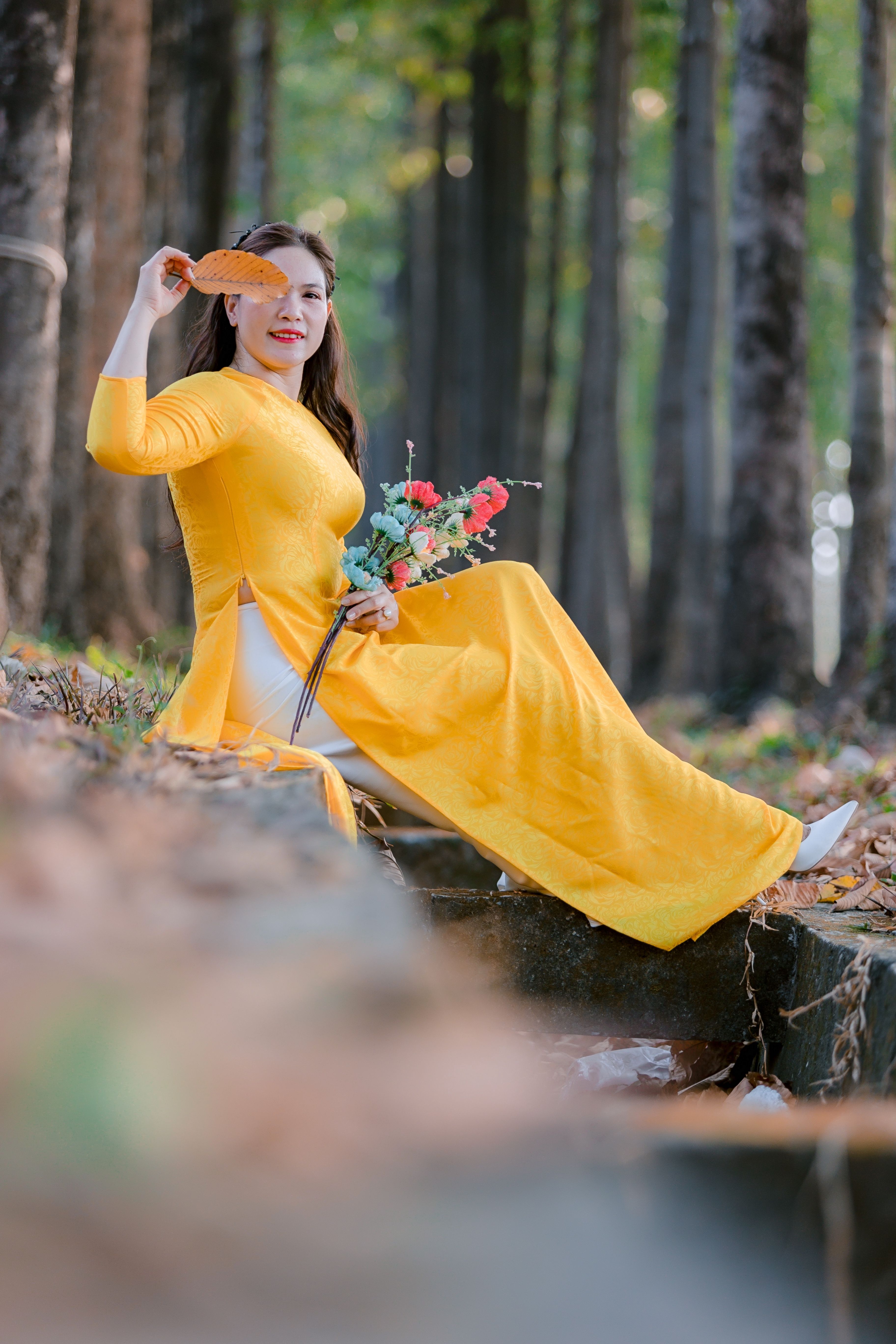 Elegant Woman in Yellow Dress in Forest Setting · Free Stock Photo