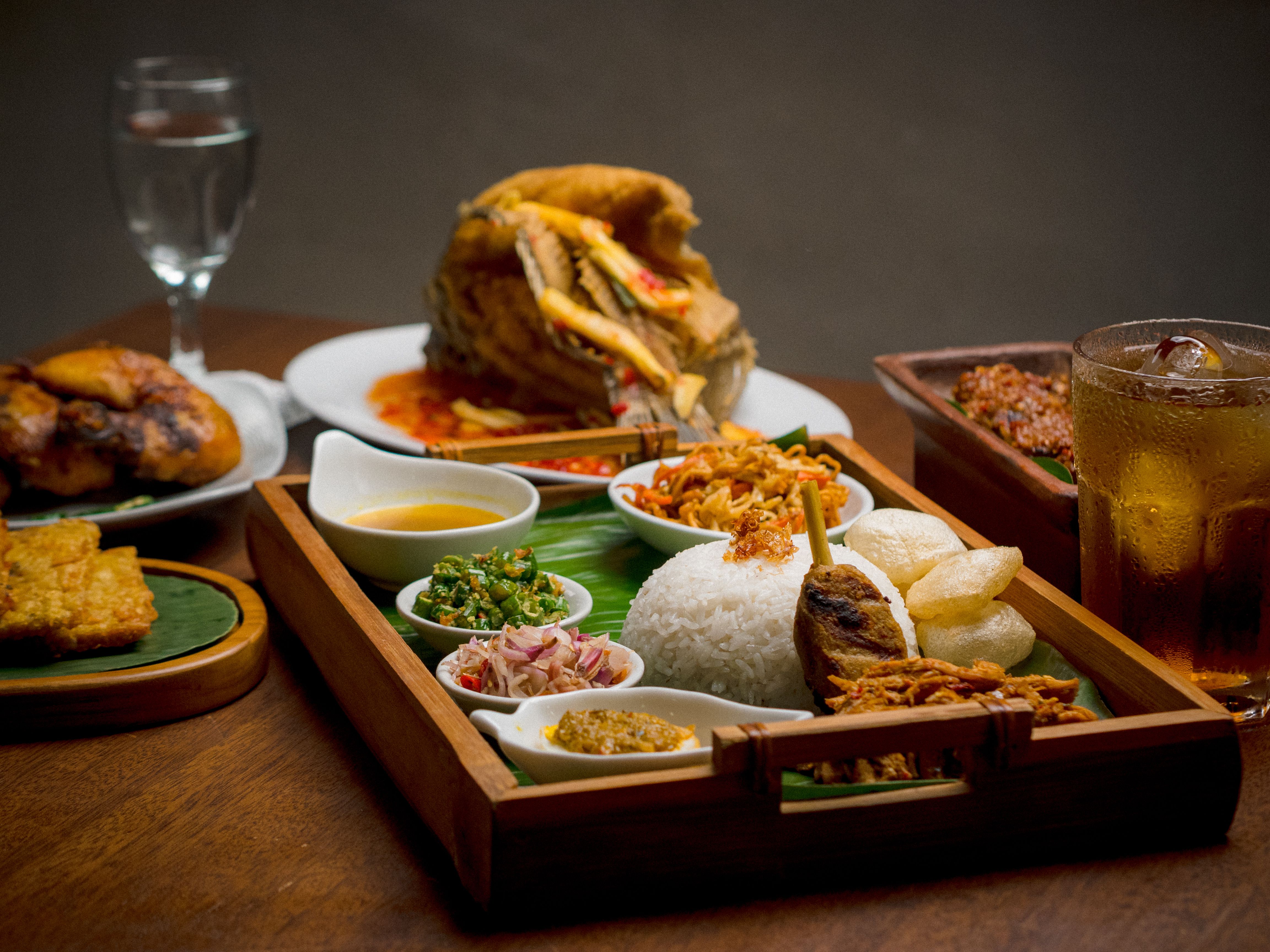 Experience an authentic Indonesian meal featuring rice, fried fish, tempeh, and sambal in Jakarta.