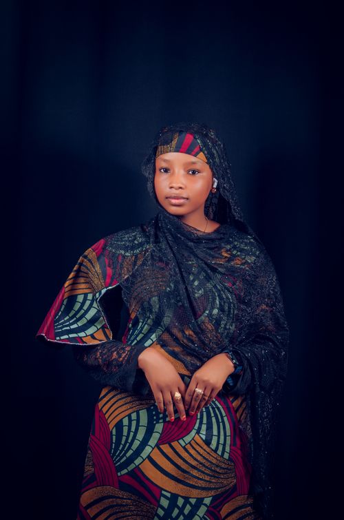 Free Elegant portrait of a woman in colorful traditional clothing with a serene expression. Stock Photo