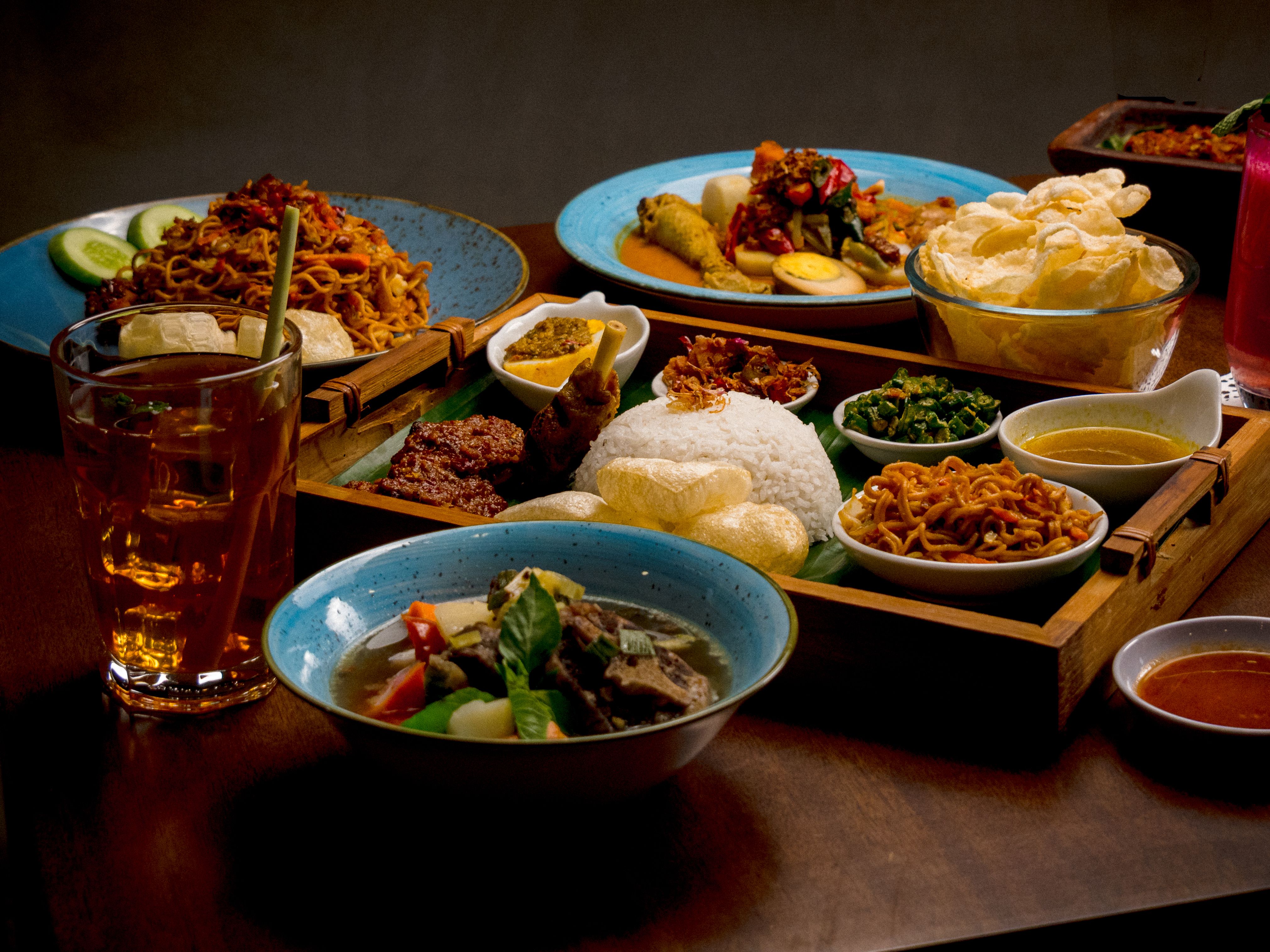 A variety of traditional Indonesian dishes beautifully arranged on a table, offering a culinary feast.
