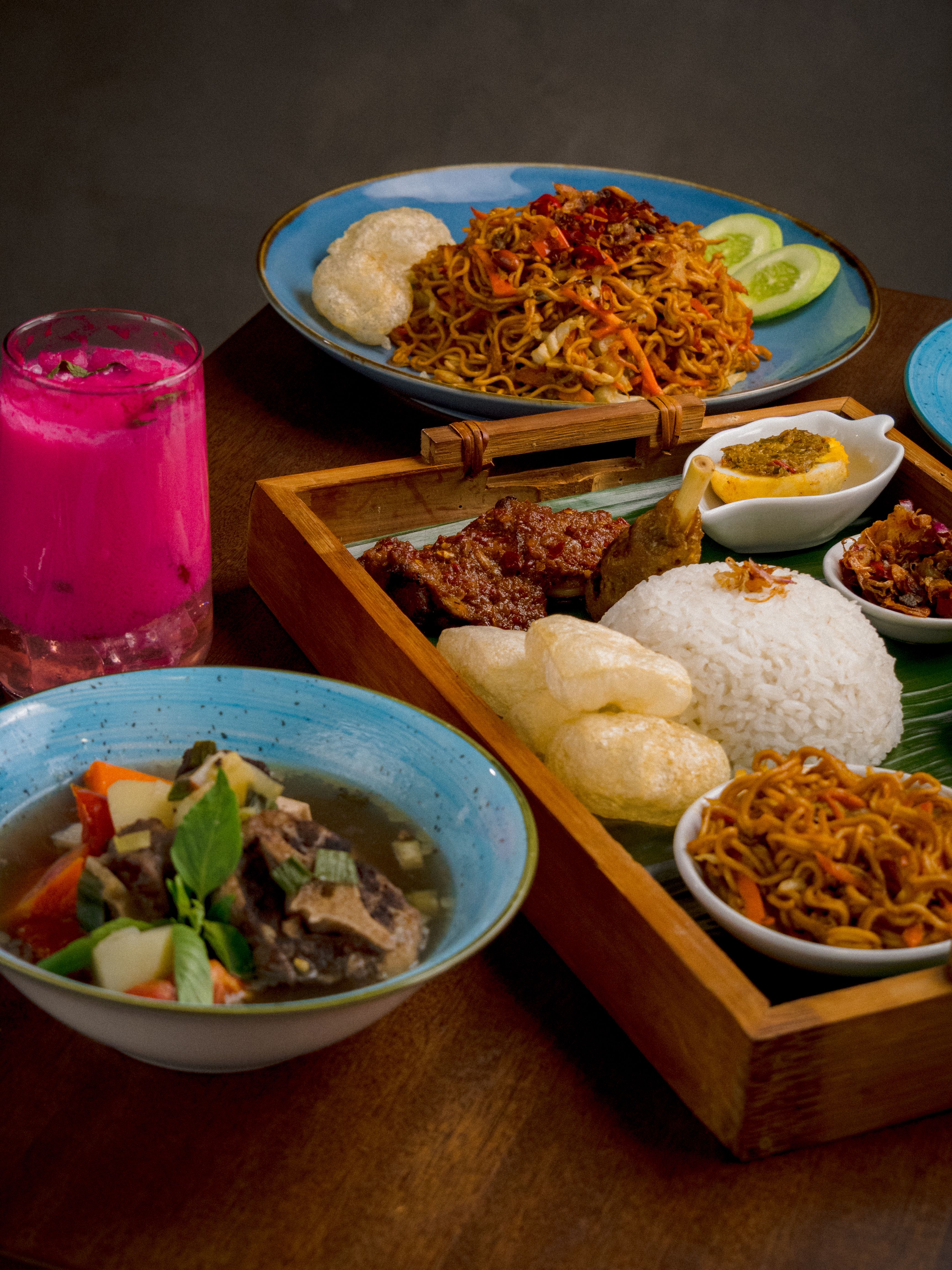 A mouthwatering assortment of traditional Indonesian dishes featuring noodles, rice, and beef in Jakarta.