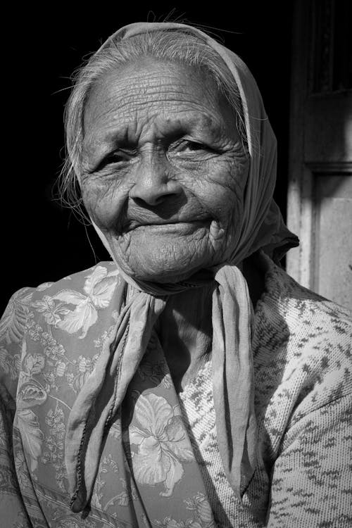 Grayscale Portrait Photo of an Elderly Woman Wearing Headscarf