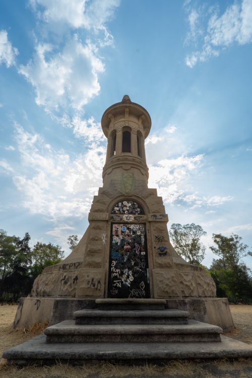Free A historic monument in Chapultepec Park, Mexico City, stands under a bright, clear sky. Stock Photo