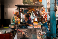 A street food vendor serving snacks in bustling Manila, Philippines street.
