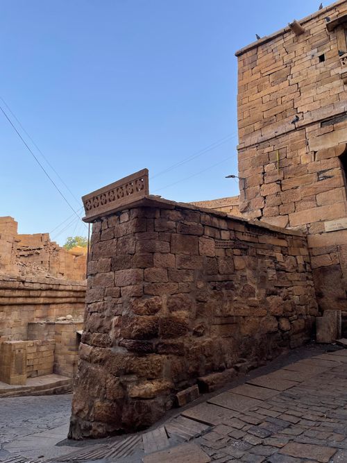 Free Ancient stone walls of Jaisalmer Fort under a clear sky in Rajasthan, India. Stock Photo