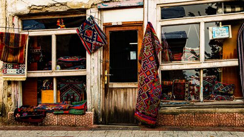 Free Vibrant traditional rug shop exterior featuring hanging colorful rugs and textiles. Stock Photo
