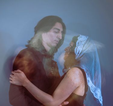 Artistic double exposure of a couple embracing, blending ethereal and emotional tones.