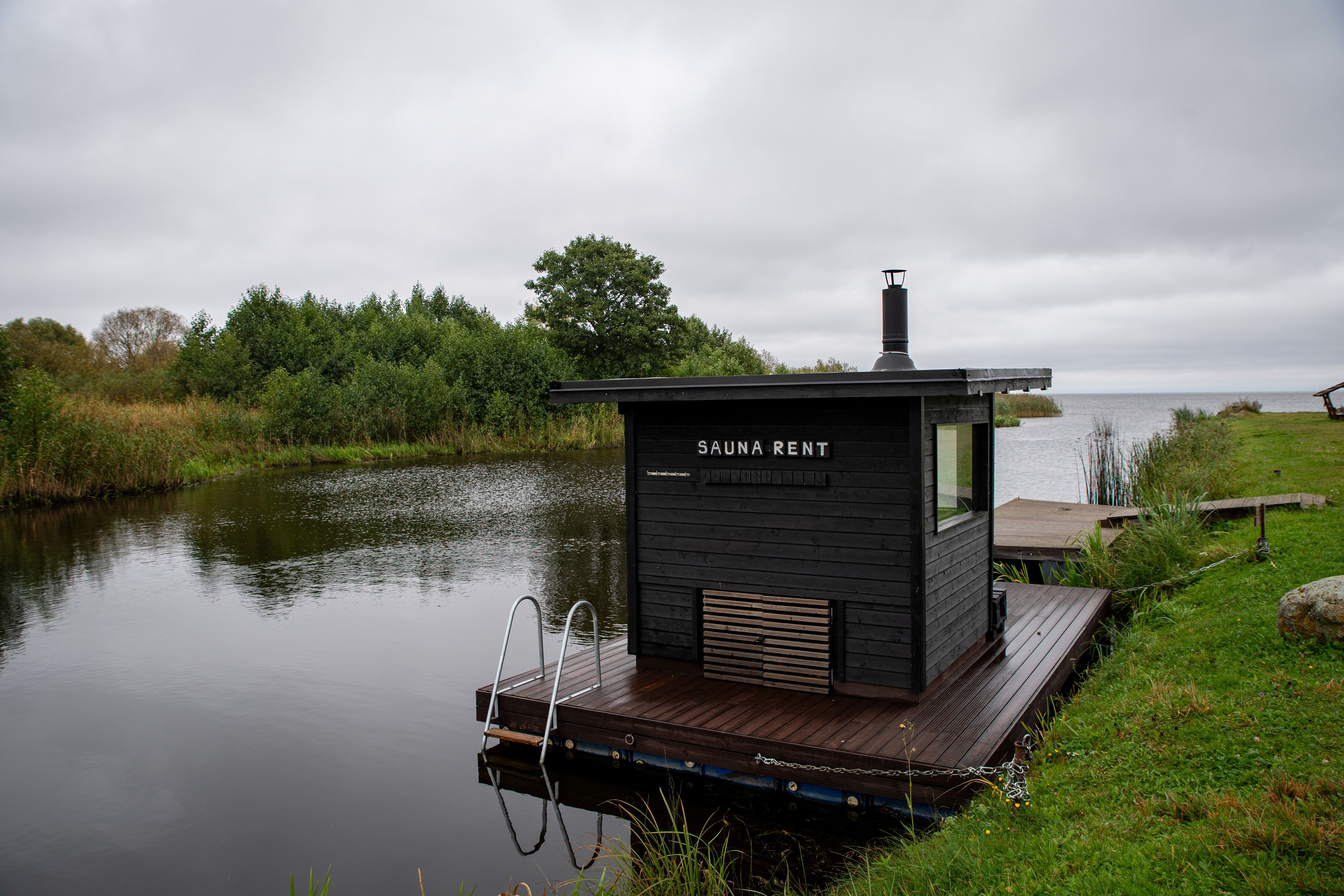 A floating sauna on a peaceful lakeside