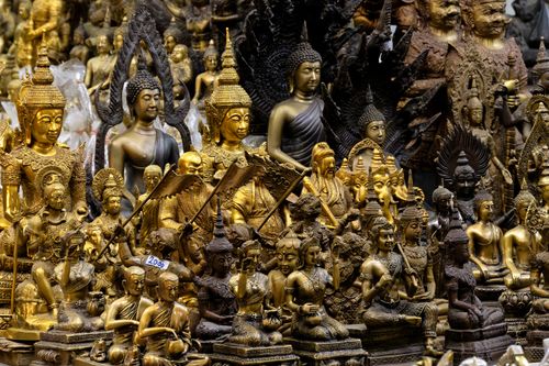 Free A detailed display of Thai Buddha statues in various poses and designs, showcasing intricate craftsmanship. Stock Photo