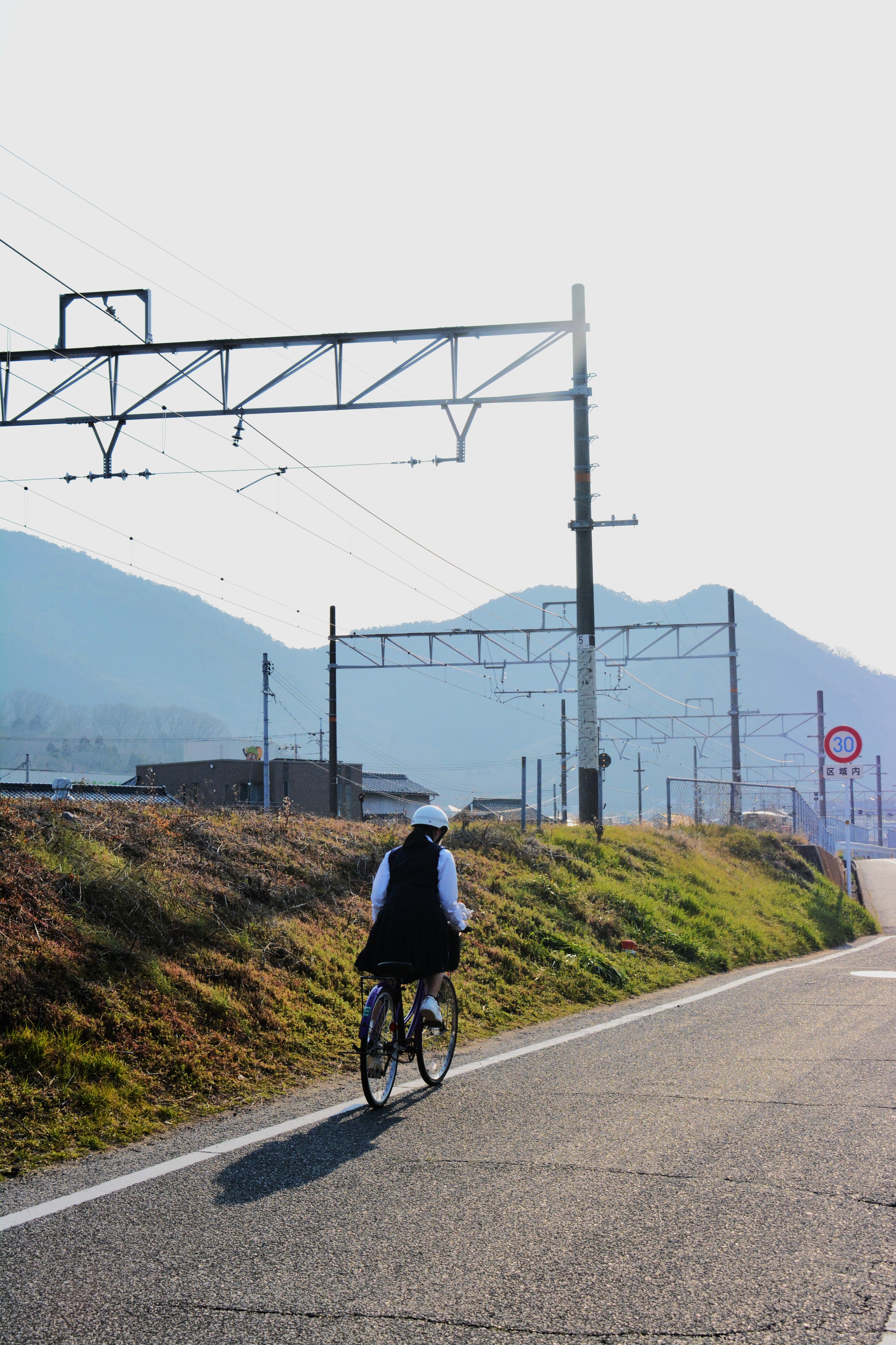 Rider on a rural road beside the mountains — photo by Noe Garde on Pexels