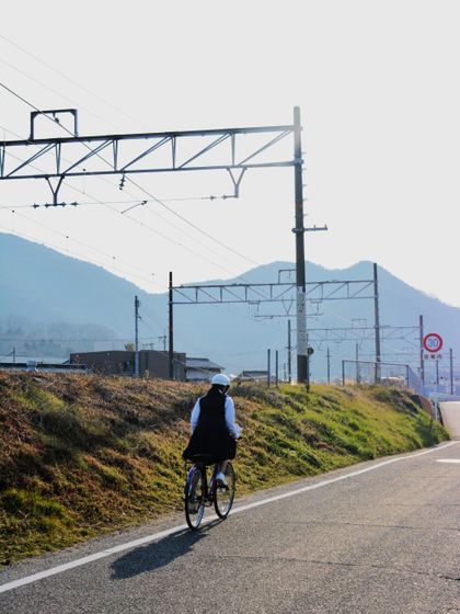 Rider on a rural road beside the mountains — photo by Noe Garde on Pexels