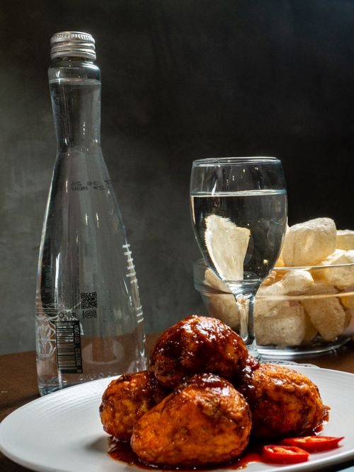 Free Delicious spicy meatballs served with crackers and water in Jakarta, Indonesia. Stock Photo
