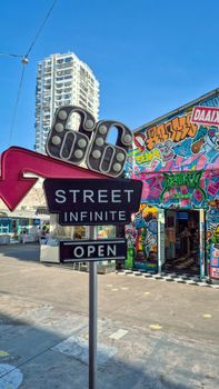 Explore the colorful urban scene with graffiti art and signage in Xiamen, China.