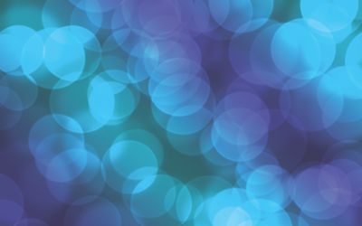 A vivid abstract bokeh background with blue and purple lights, perfect for design use.