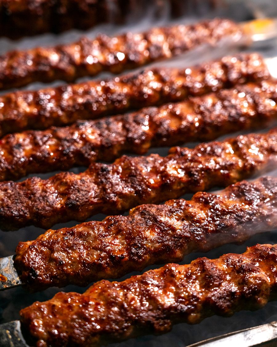 Seekh kebabs grilling on skewers