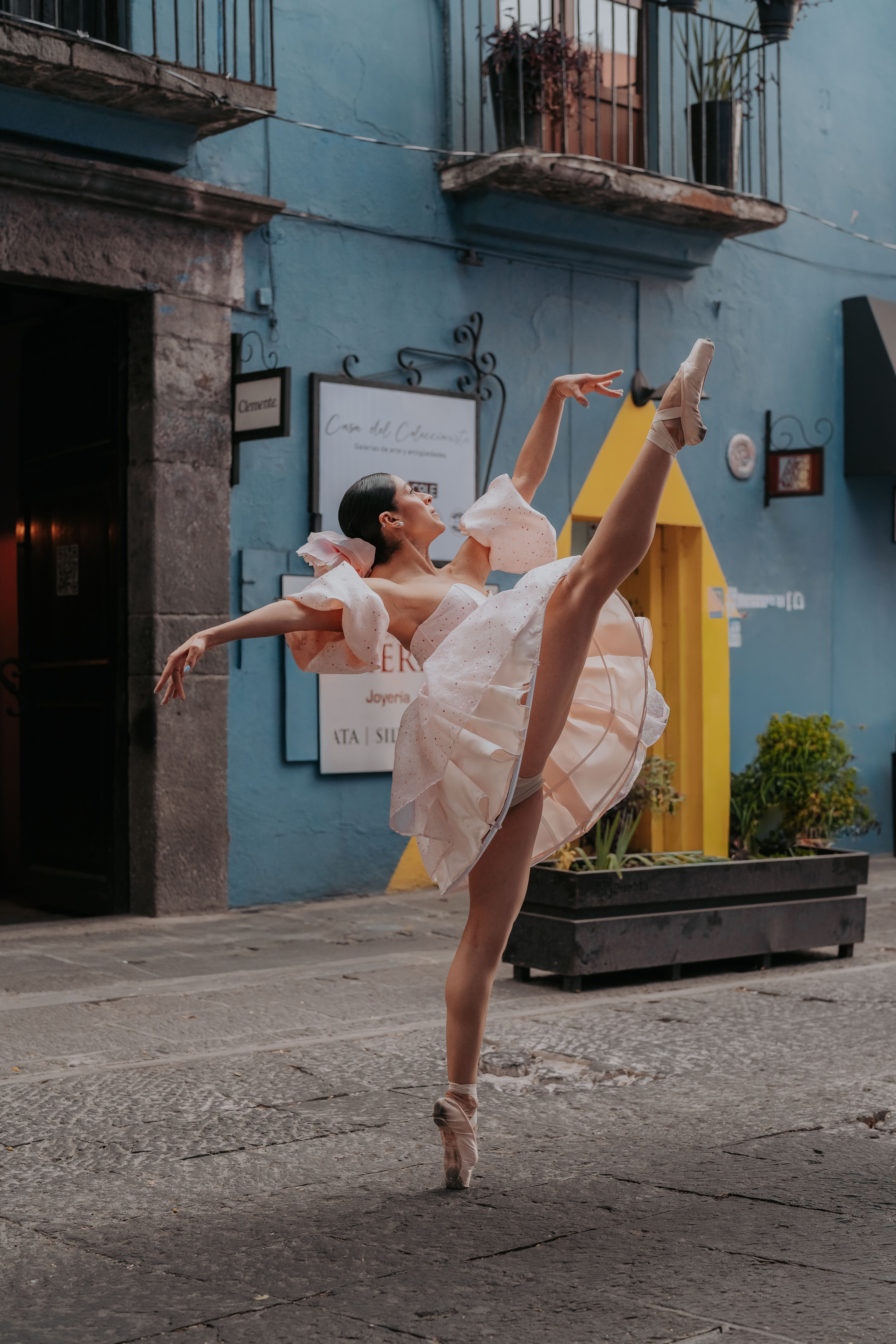 Elegant ballerina in white dress performing outdoors in Puebla, Mexico.