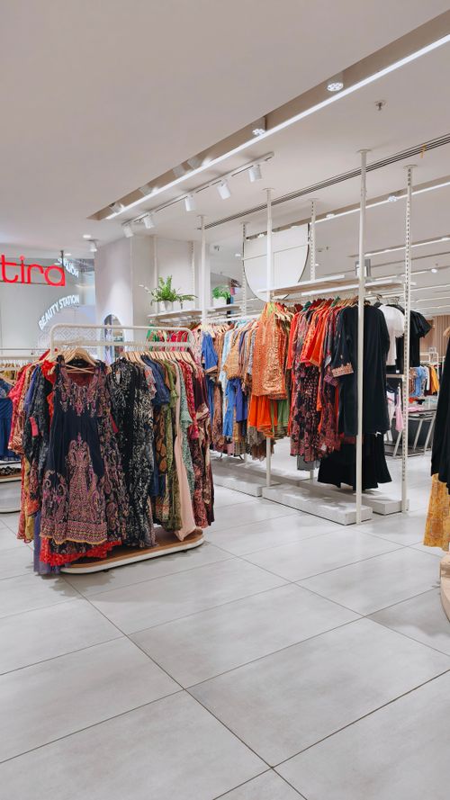 Free Rows of colorful clothing on racks in a stylish fashion boutique interior. Stock Photo