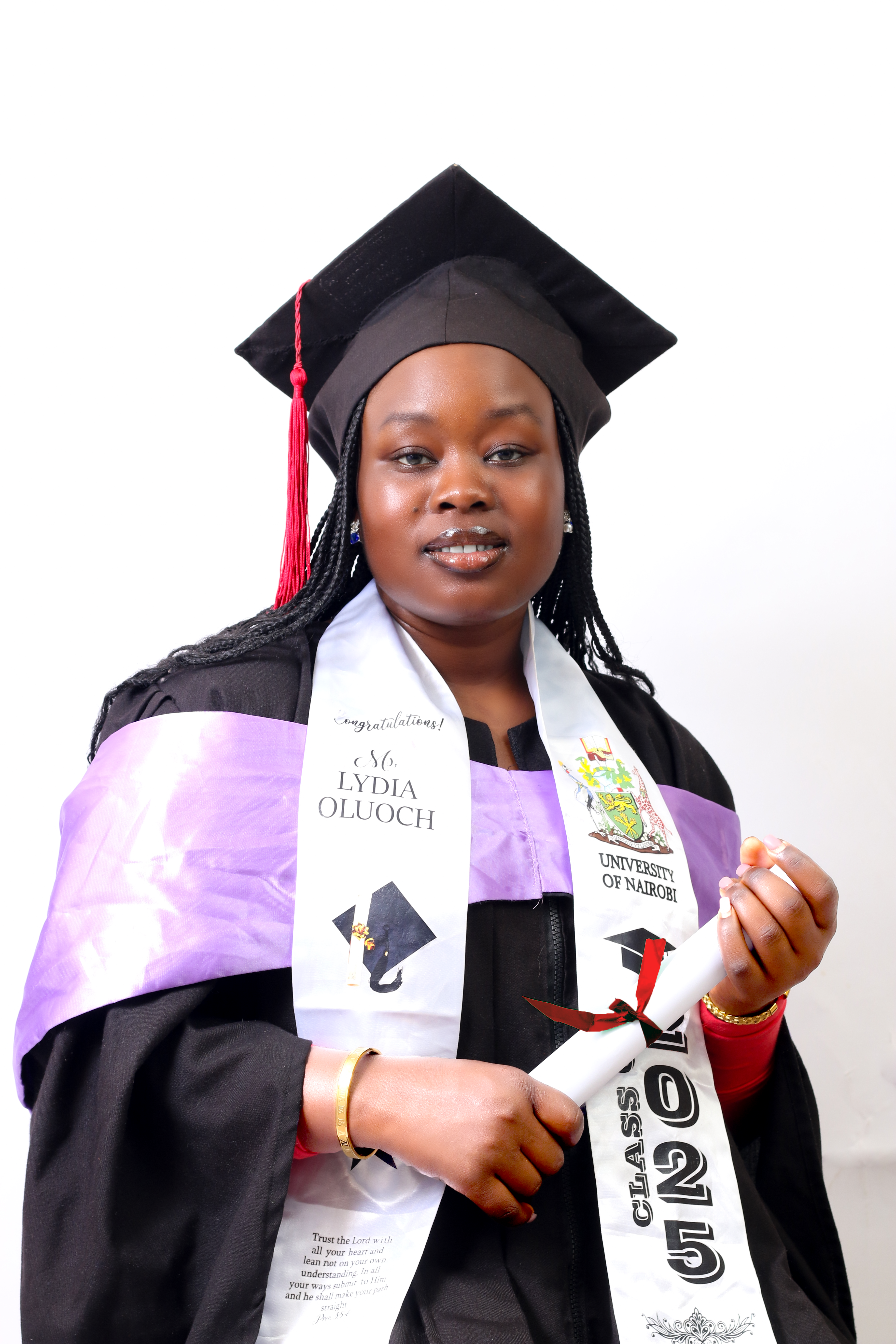 Young female graduate poses proudly in her cap and gown, holding a diploma.
