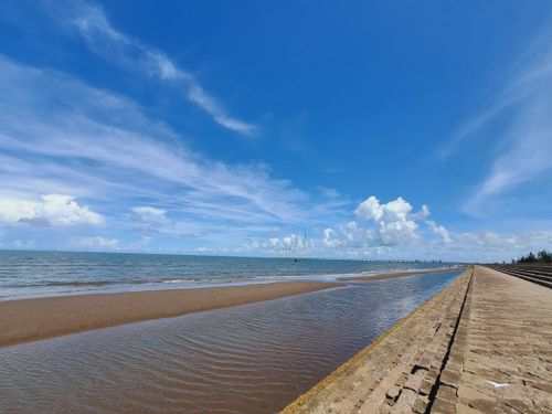 Free Calm sandy beach with clear waters under a bright blue sky in Truong Long Hoa, Vinh Long, Vietnam. Stock Photo