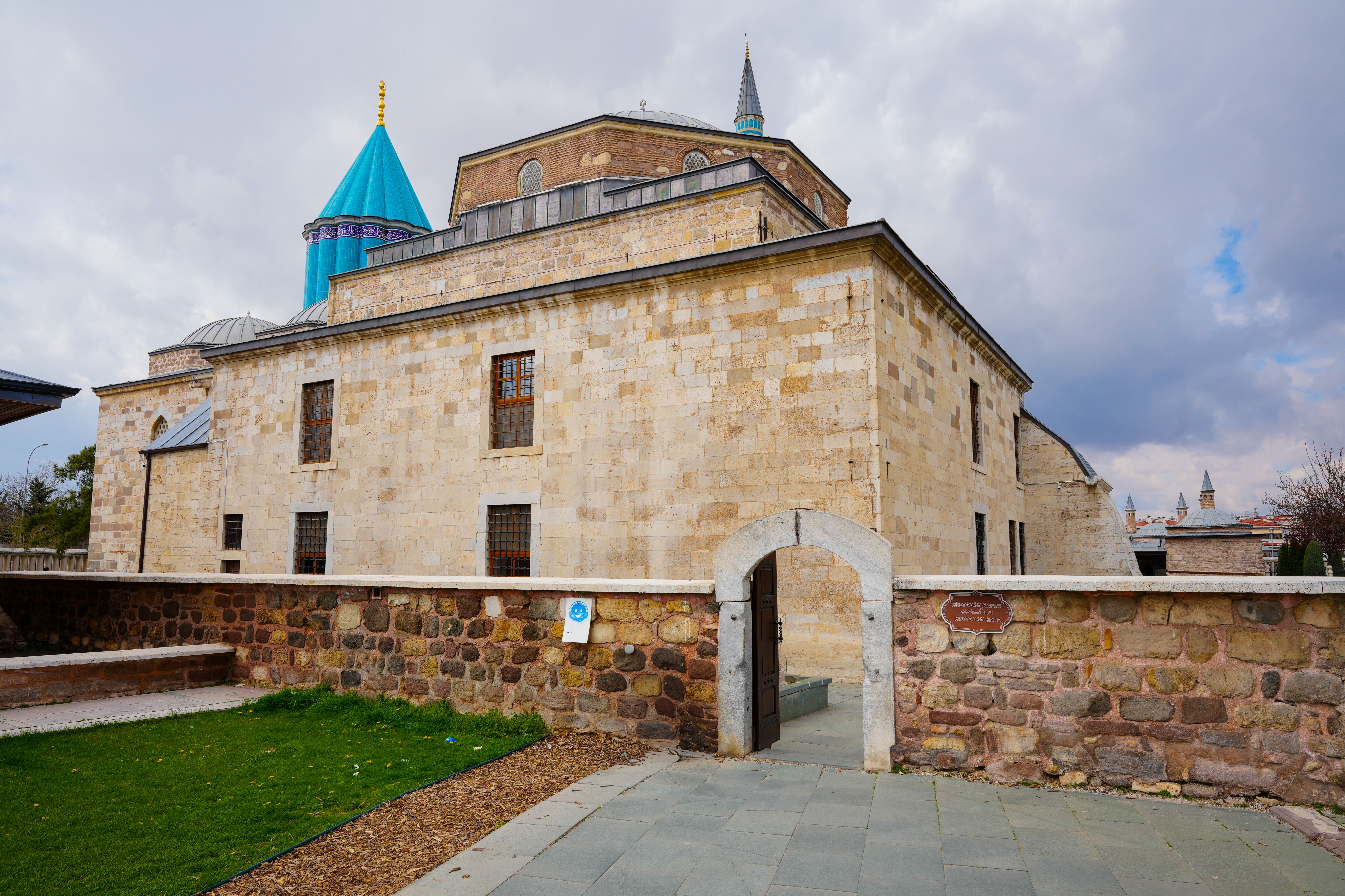 Konya Mevlana Museum Turkey with iconic turquoise dome, ornate tilework, and serene courtyard bathed in golden afternoon sunlight