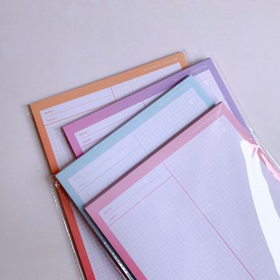Stack of grid paper notebooks on a table — photo by Phương Trần on Pexels