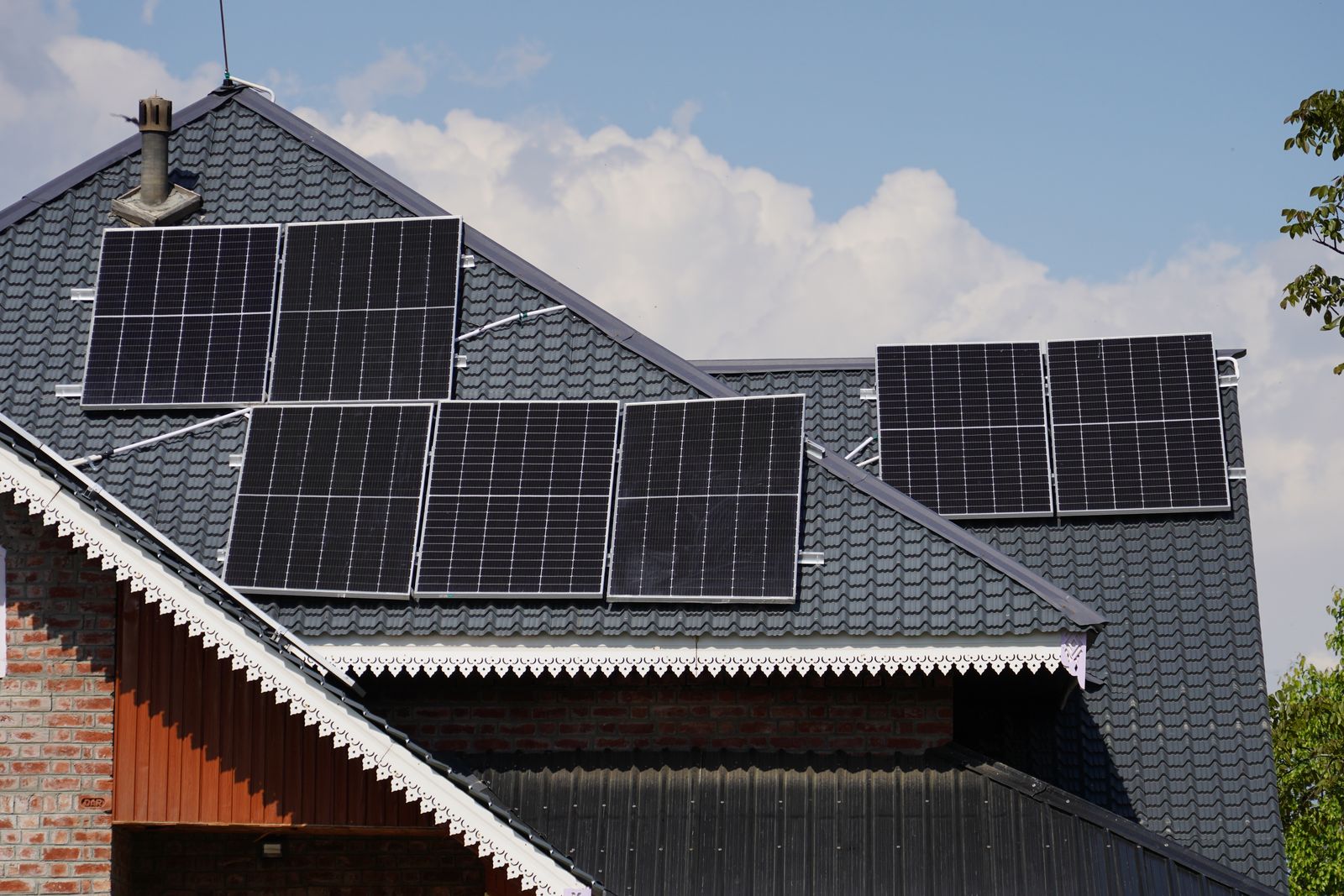 Rooftop solar panels on a residential home against a blue sky