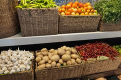 A colorful assortment of fresh vegetables beautifully arranged in wicker baskets.