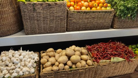 A colorful assortment of fresh vegetables beautifully arranged in wicker baskets.