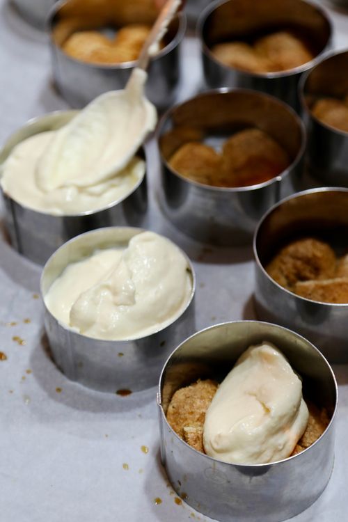 Free Close-up of tiramisu dessert being prepared in metal molds with creamy layers. Stock Photo
