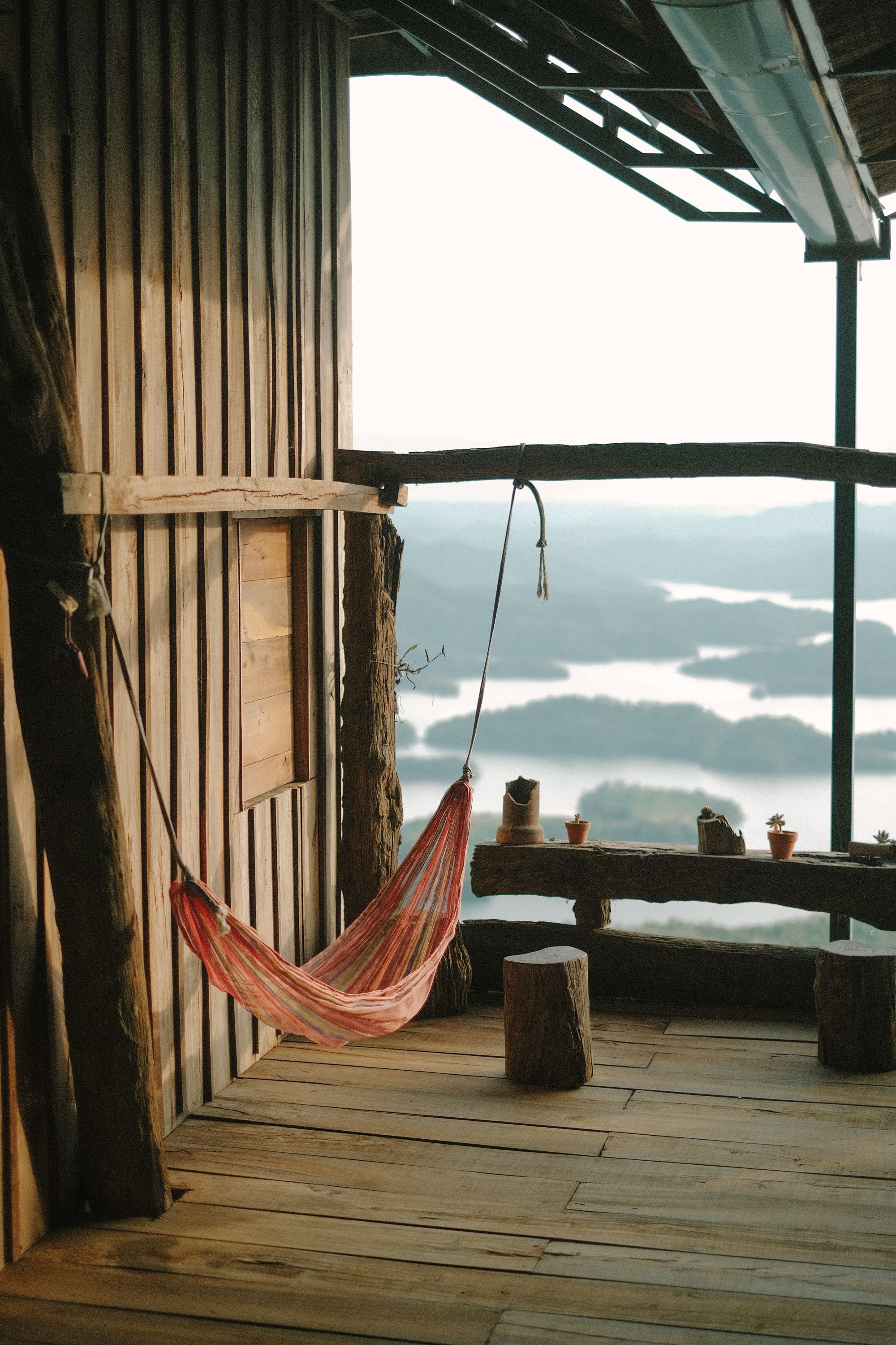 Rustic Cabin with Hammock Overlooking Serene Lake · Free Stock Photo