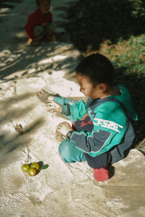Free Young boy playing outside on a sunny day with colorful toys. Stock Photo