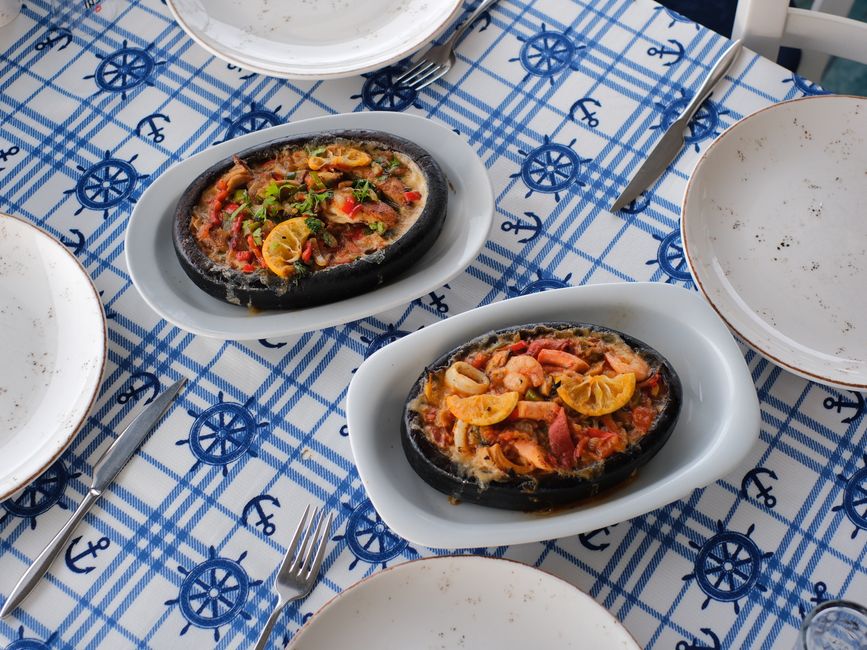 A seafood hotplate on a nautical-themed table setting, perfect for a coastal dining experience.