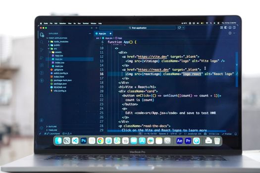 Laptop with code editor open on a rooftop, showcasing remote web development and modern work flexibility.