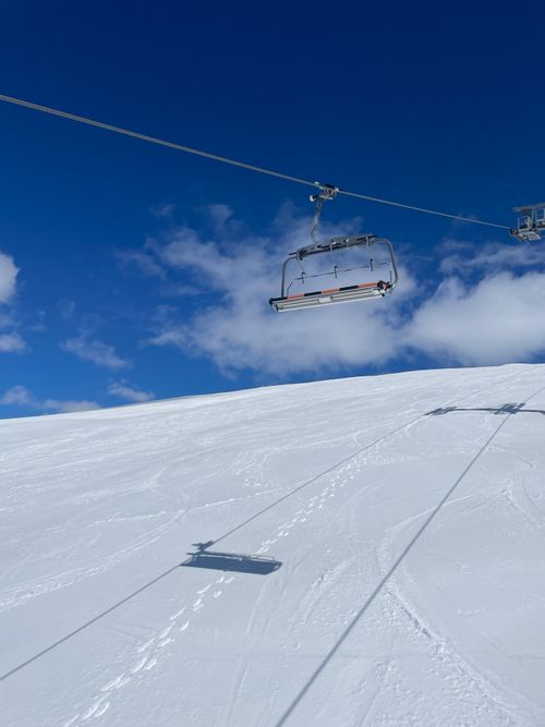 Free Empty ski lift over a snow-covered mountain slope in Montenegro with a vivid blue sky. Stock Photo