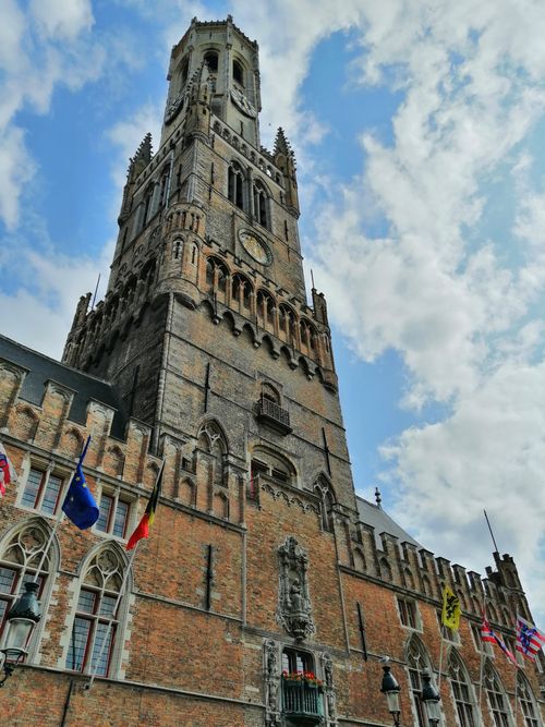 Free Stunning view of the historic Belfry of Bruges under a cloudy sky. Stock Photo