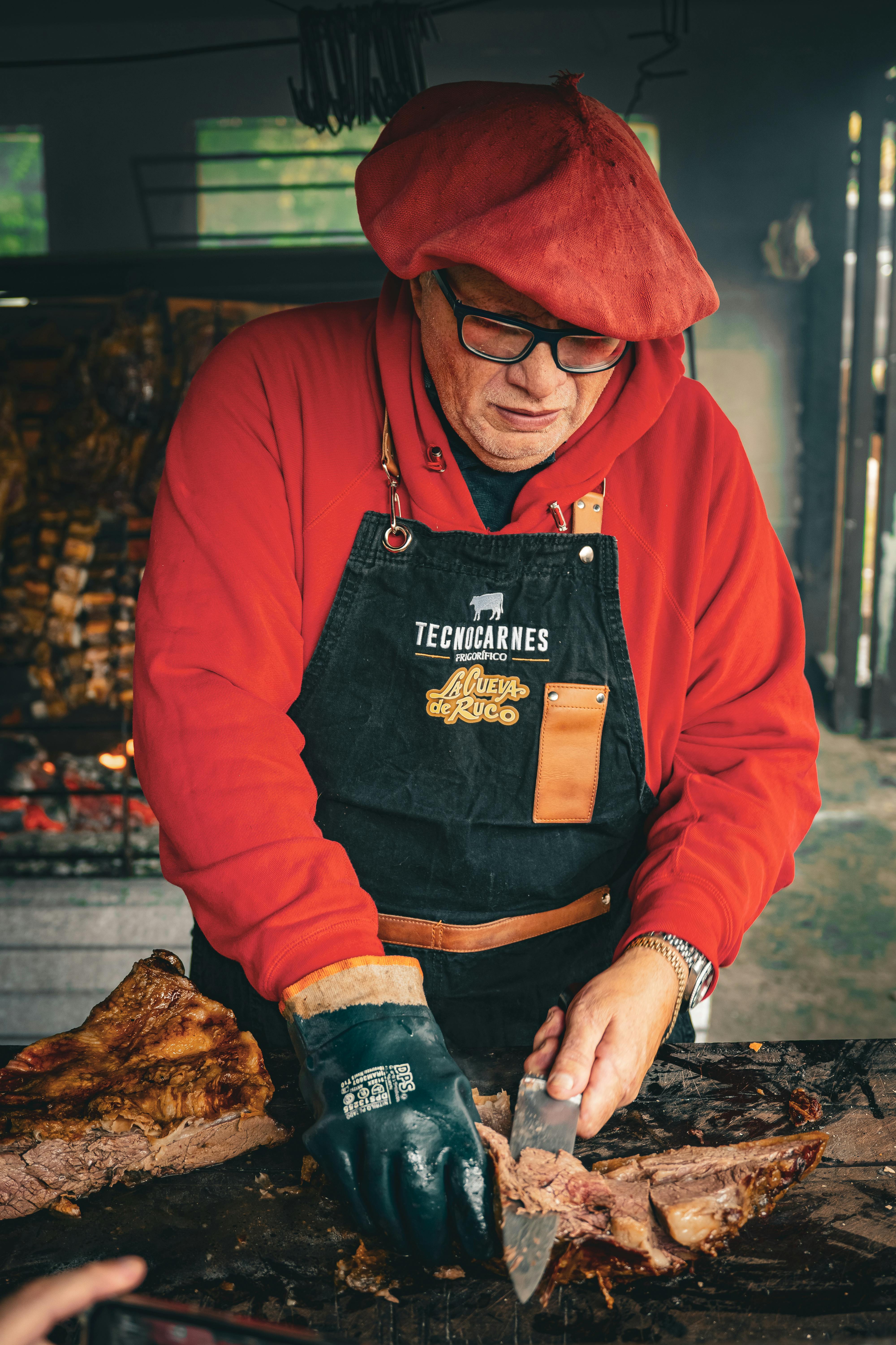 BBQ pitmaster checking thermometer reading on smartphone at competition