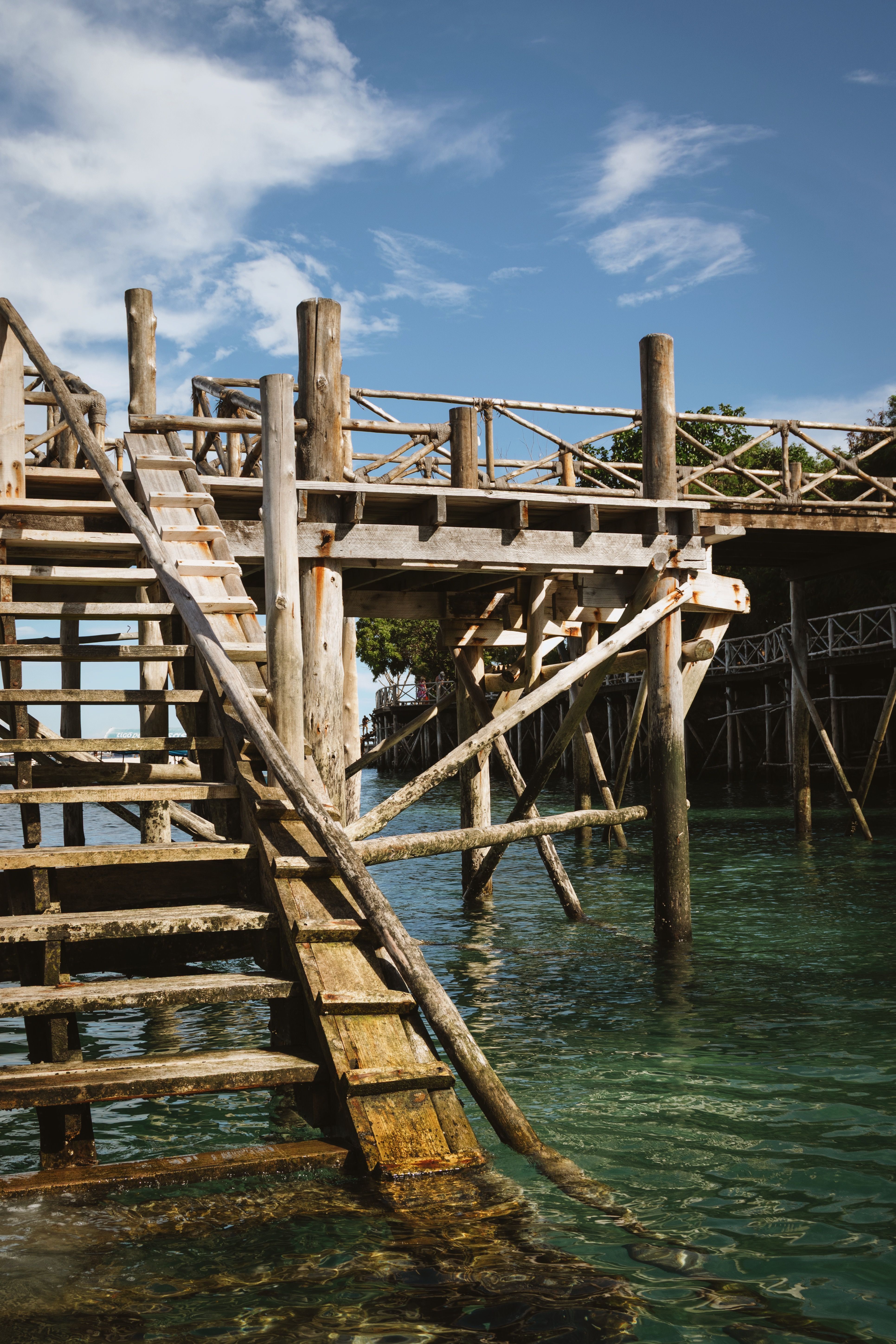 Rustic Wooden Pier Over Clear Zanzibar Waters · Free Stock Photo