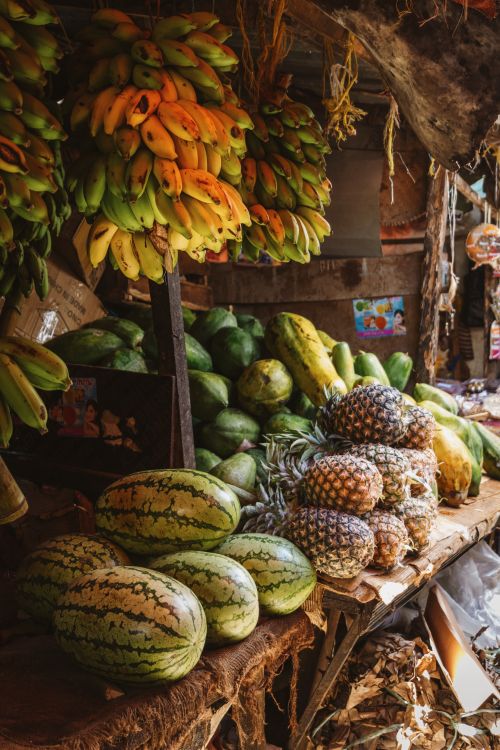 Free Fresh tropical fruits displayed at a vibrant market stall in Zanzibar, Tanzania. Stock Photo