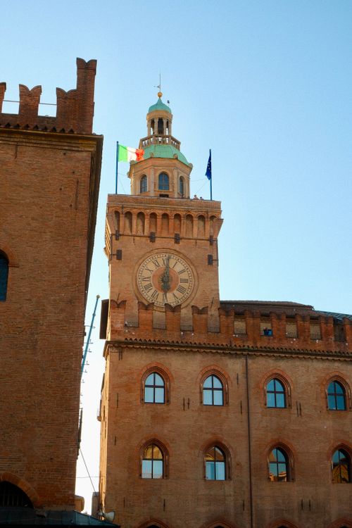 Free The Torre dell'Orologio in Bologna, Italy, captured at sunset displaying its architectural beauty. Stock Photo