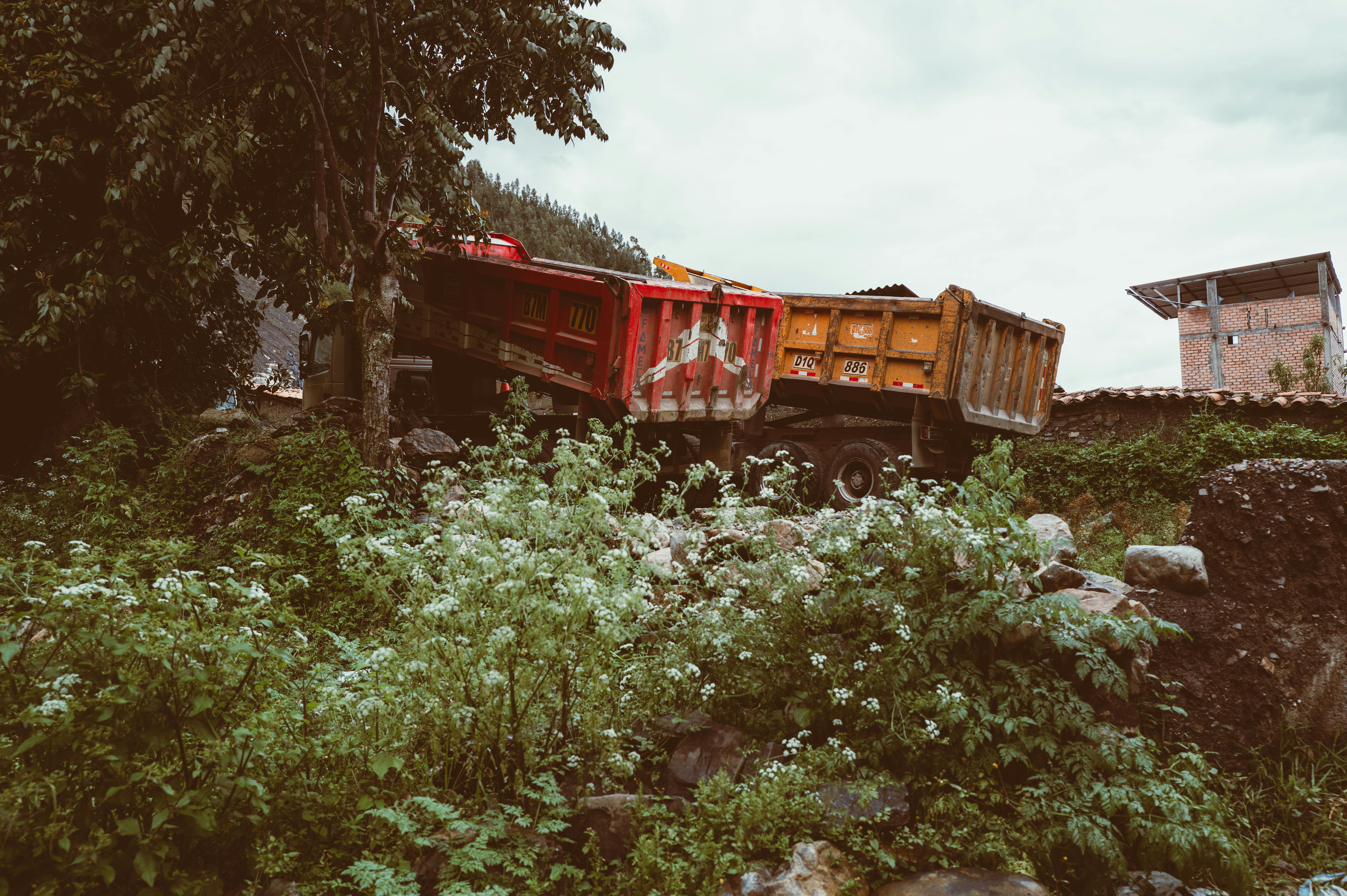 A colorful dump truck sits amidst lush greenery in Huaraz, a town in the Peruvian Andes.