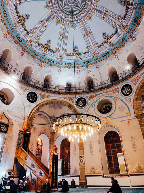 Free Intricately decorated mosque interior with an ornate dome and beautiful chandelier. Stock Photo