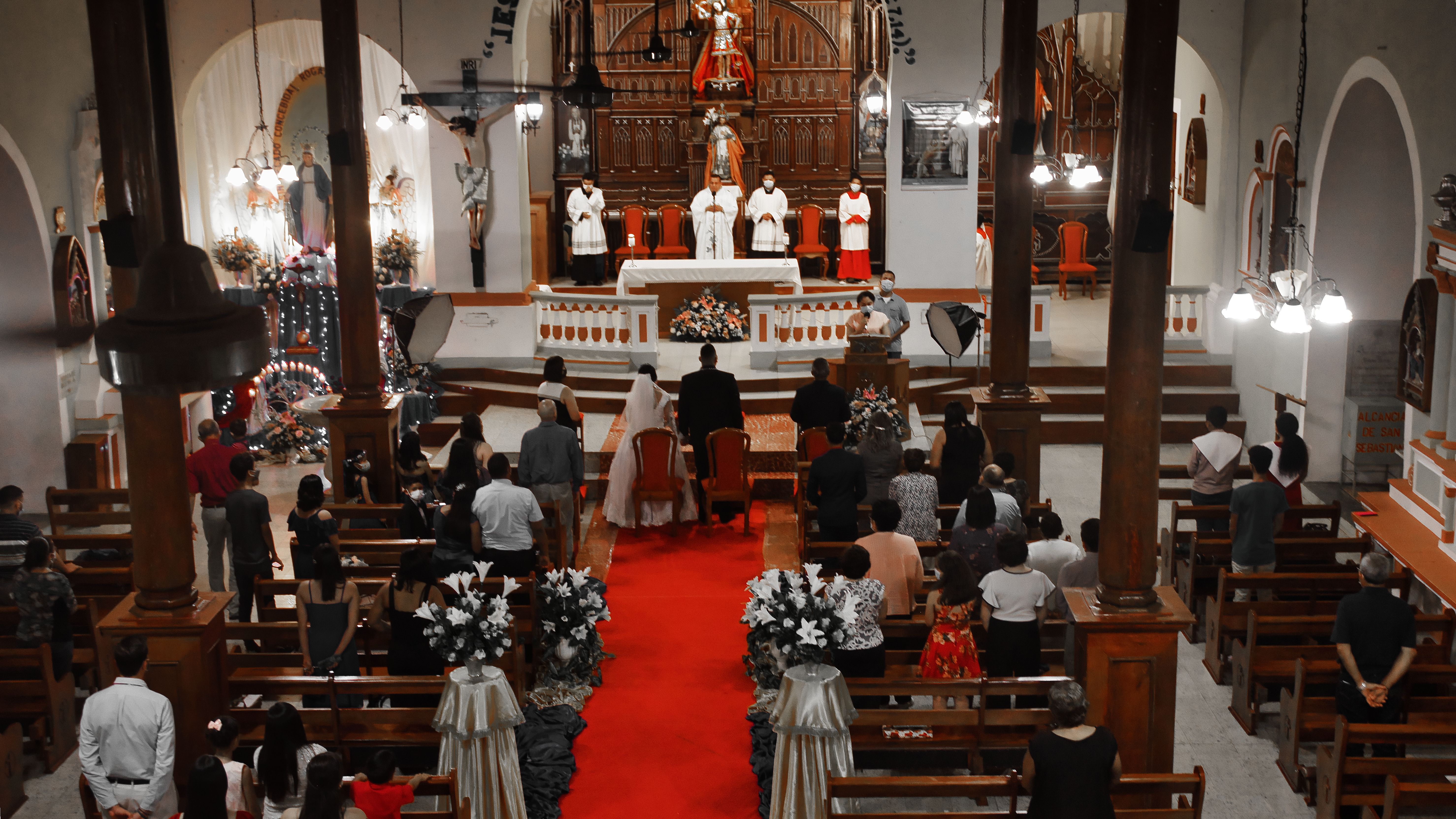 Captivating wedding ceremony captured inside a beautifully adorned historic church.