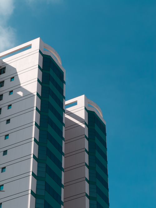 Free Contemporary high-rise building against a vivid blue sky in Miri, Sarawak, Malaysia. Stock Photo