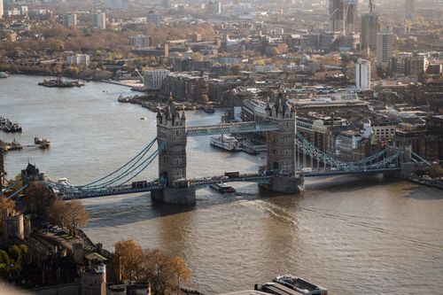 Free Aerial view of the iconic Tower Bridge spanning the River Thames in London, UK. Stock Photo