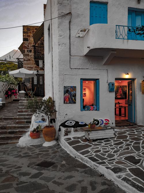 Free A picturesque scene of traditional Cycladic architecture with vibrant blue accents at dusk. Stock Photo