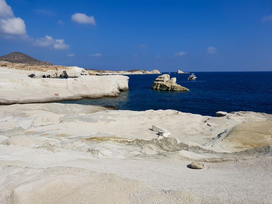 Sarakiniko Beach's white rock formations and clear blue sea in Milos, Greece.